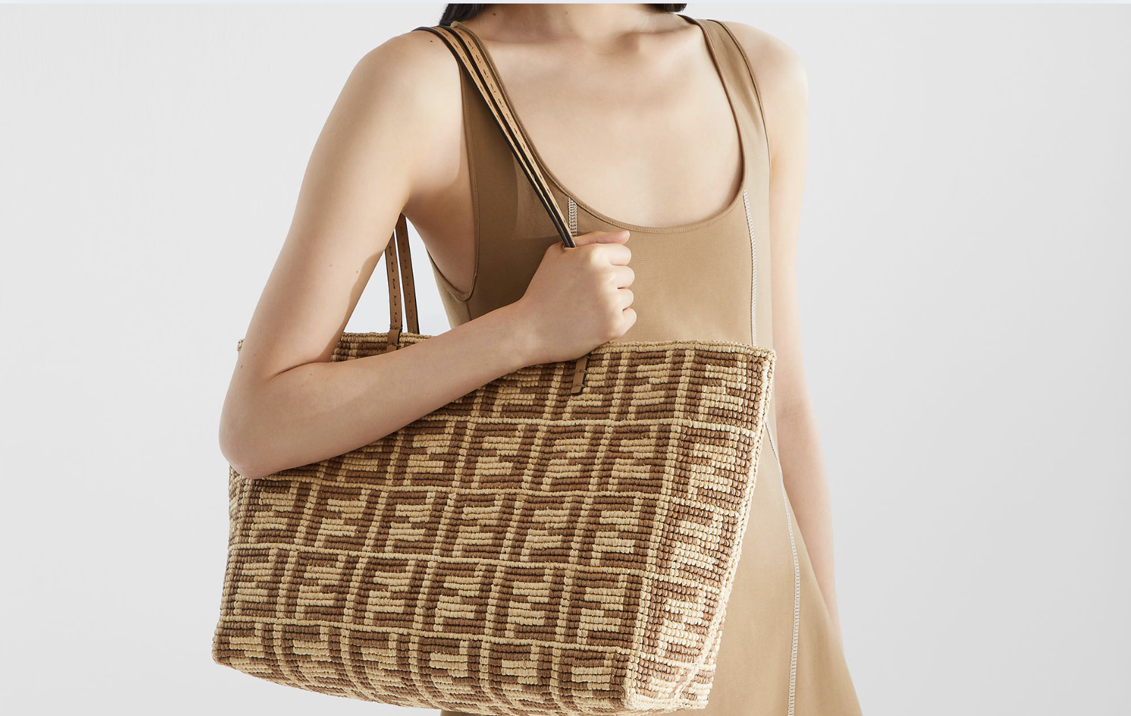 Faux FENDI tote resting beside vacation essentials