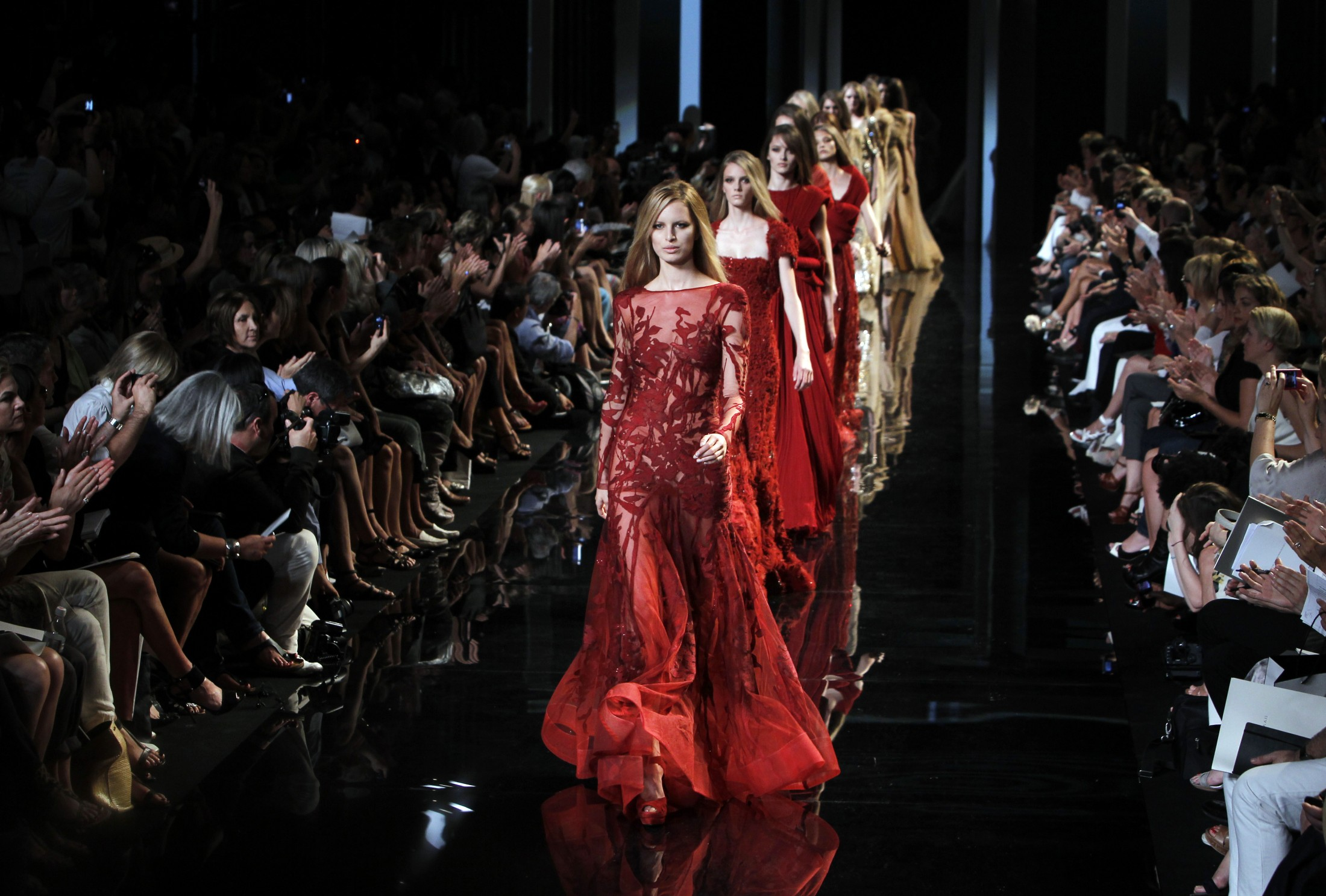 Luxury on the runway, stitched in silence. The true cost walks behind the curtain.<br />
